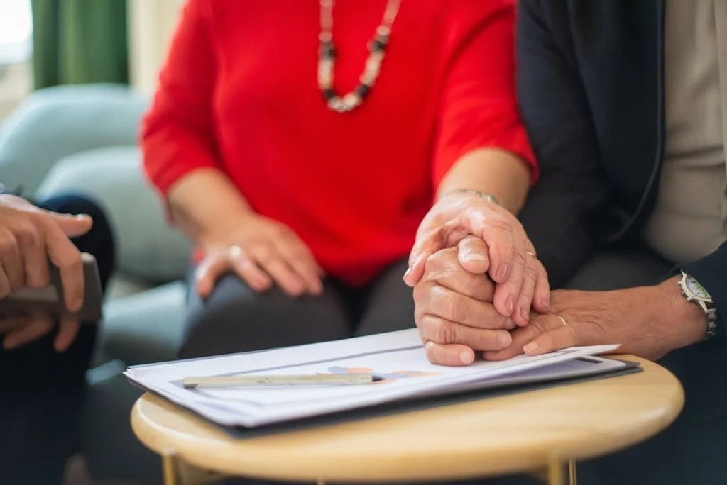 A couple reviewing and signing closing documents together
